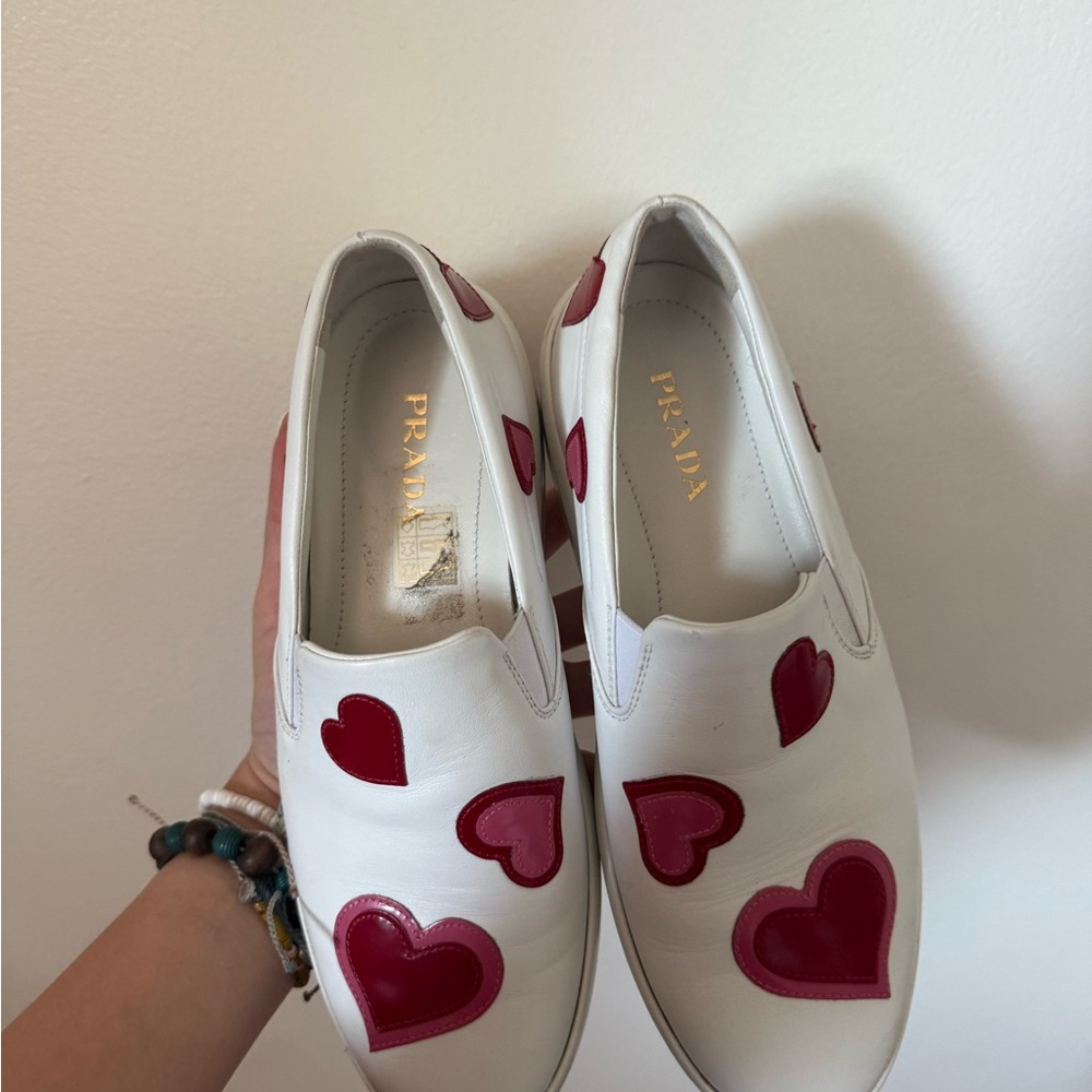 Prada White Slip-Ons with Red Heart Accents